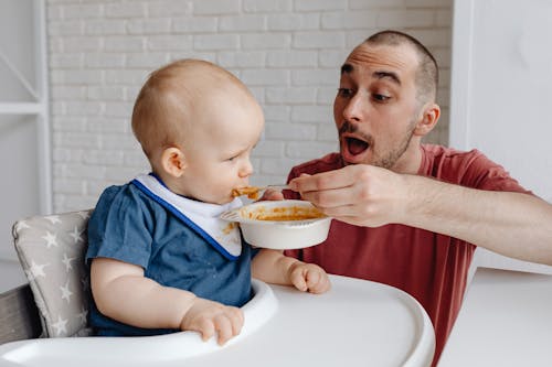 toddler sitting in high chair during meal time