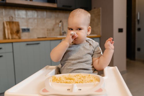 toddler throwing food on the floor during mealtime
