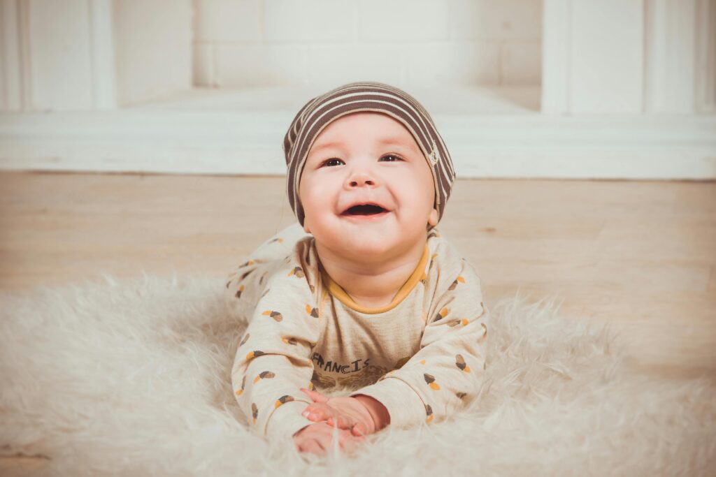 baby lying on back looking up with curiosity