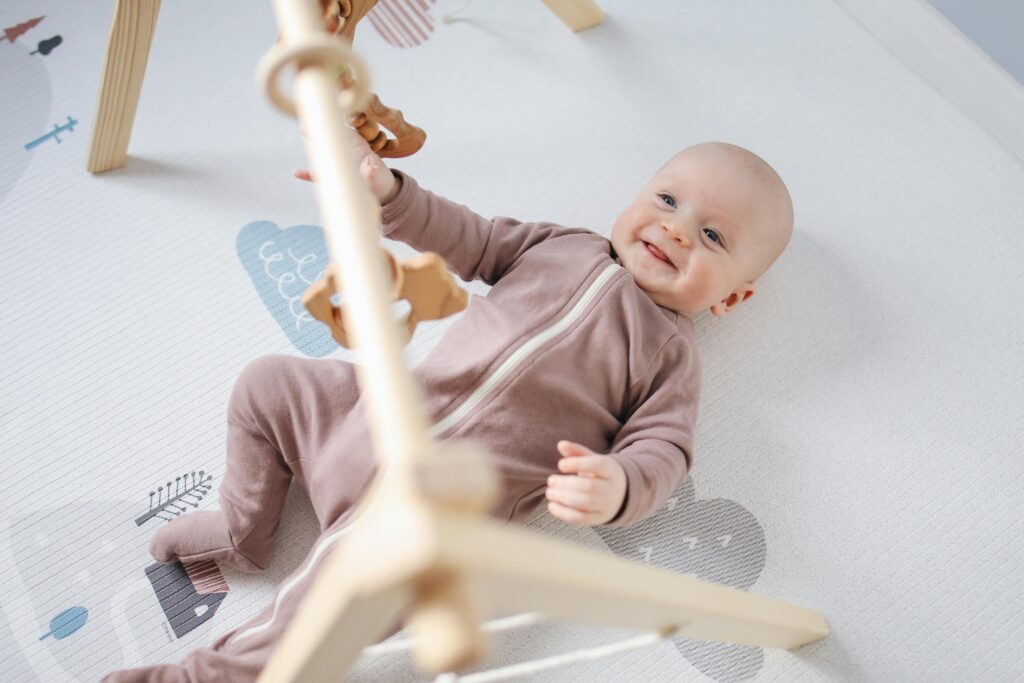 baby staring at ceiling fan with curiosity