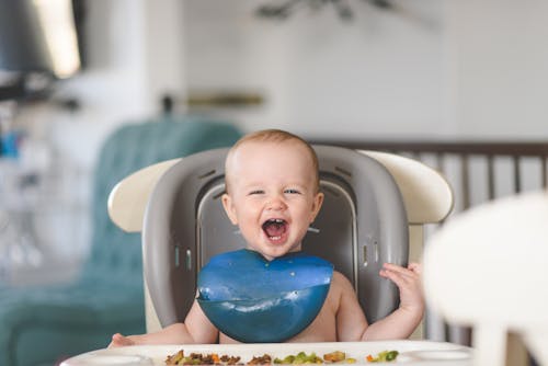 happy toddler eating meal