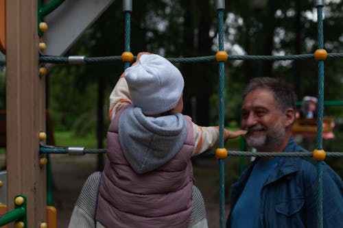 parent calling toddler at playground during outdoor play