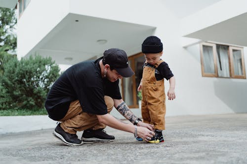 parent trying to put shoes on toddler during morning routine