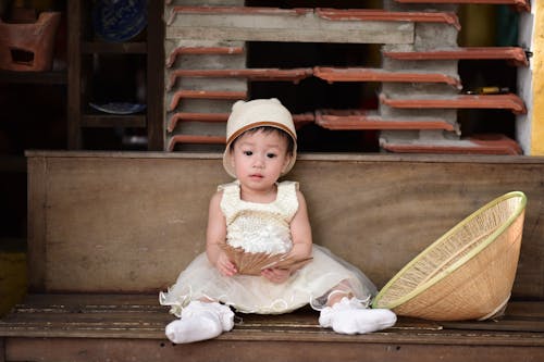 toddler sitting outside without wearing shoes